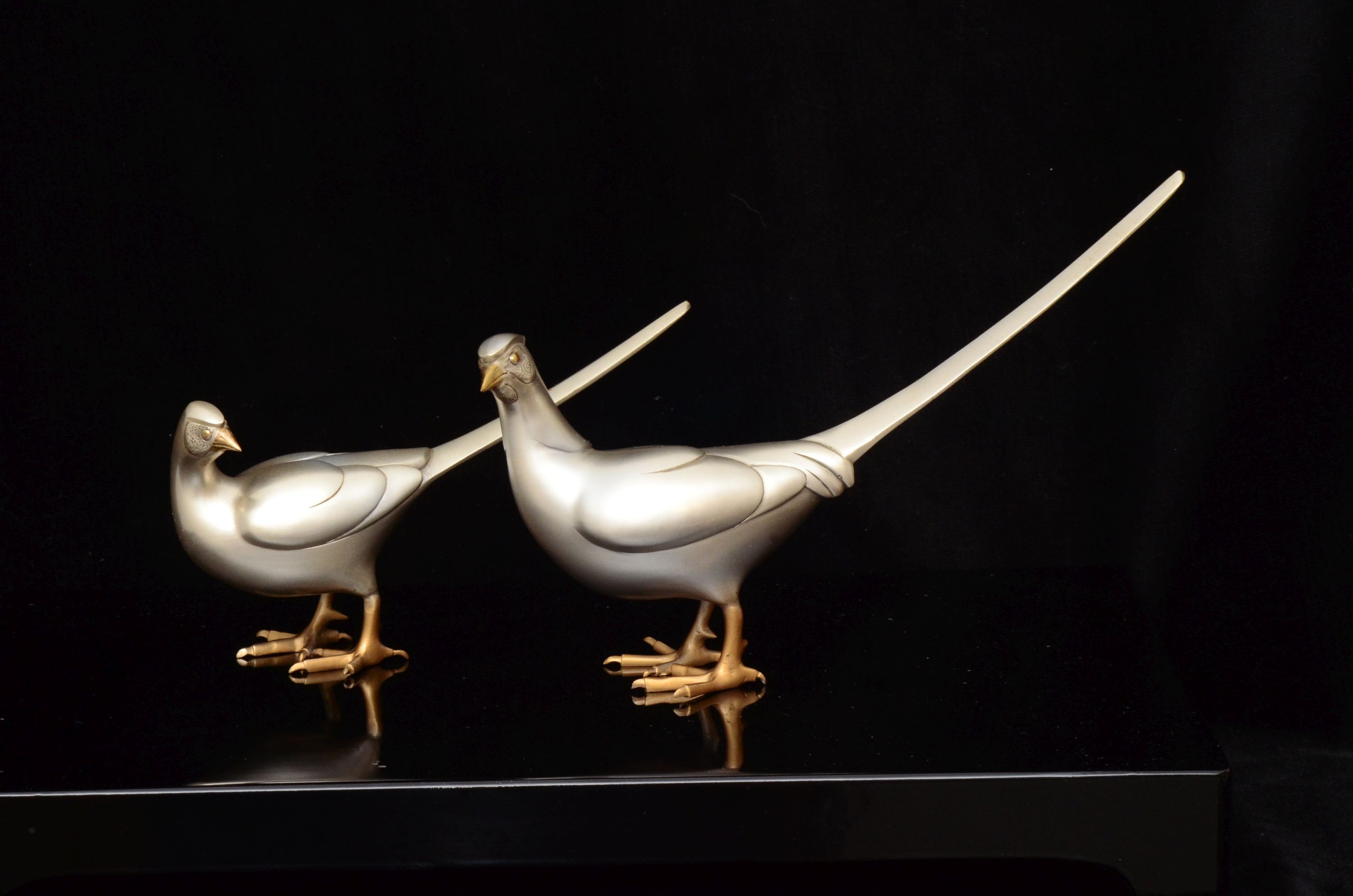 Two 20th century Japanese patinated bronze pheasants with lacquer stand, in original box